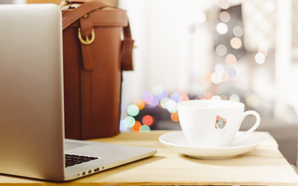 Photo of a tablet and a cup of coffee